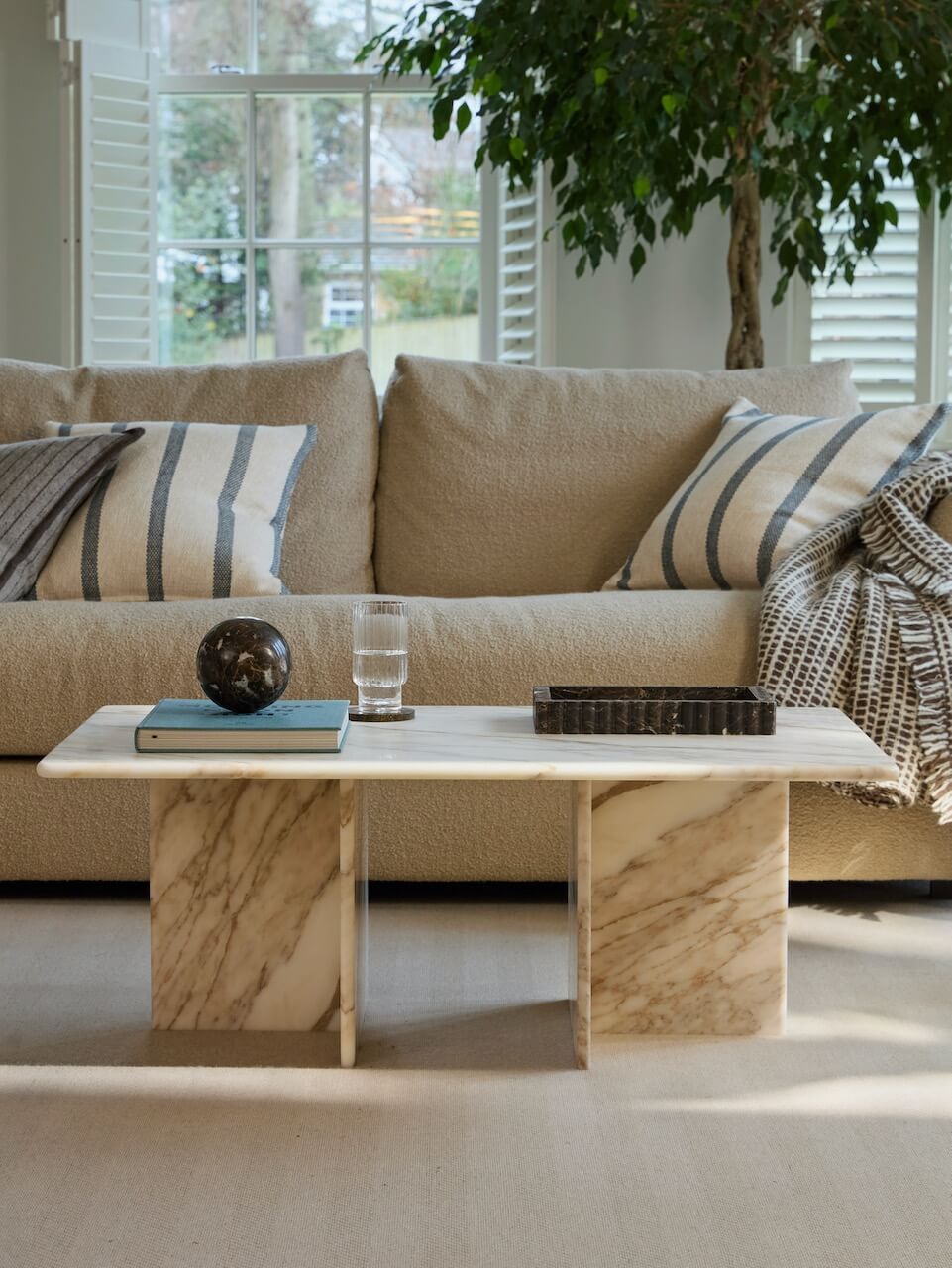 Calacatta gold marble coffee table in a warm neutral living room