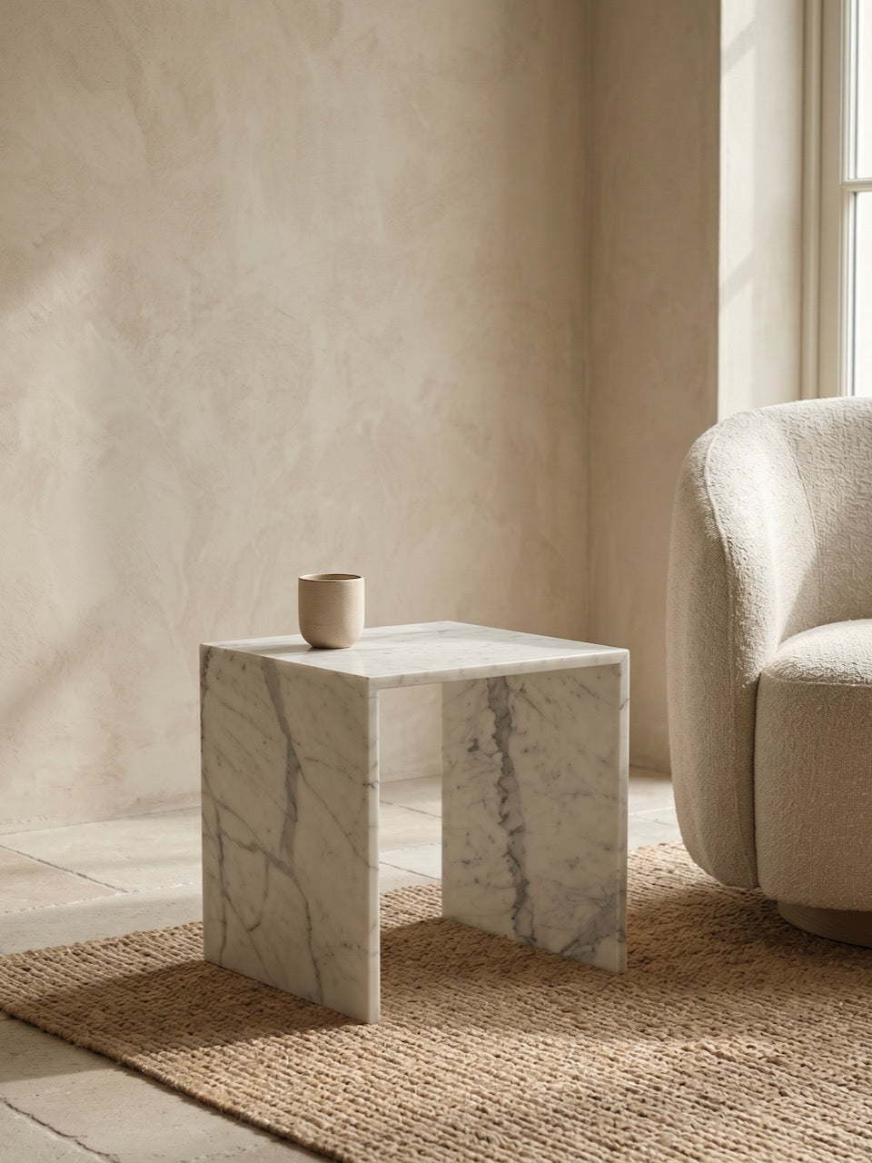Malvern Arabesque marble side table with natural veining styled in a neutral interior