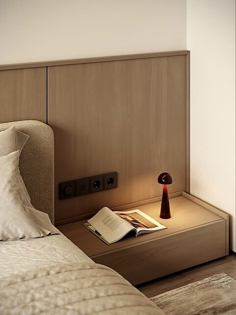 Zanzi cordless rechargeable table lamp in burgundy on bedside table creating warm ambient lighting modern bedroom dimmable lamp