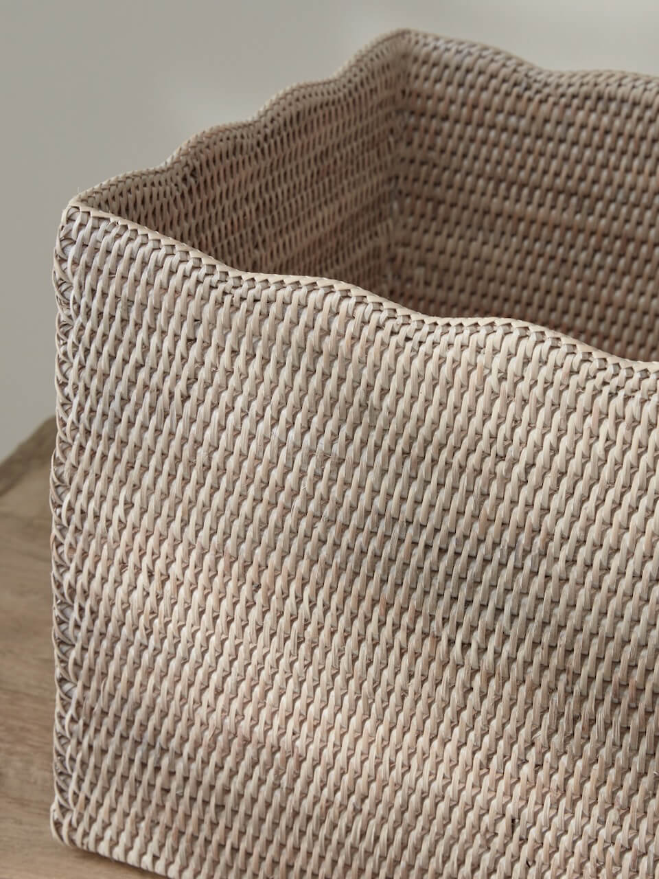 White rattan scalloped edge basket close-up showing handwoven detail and premium natural weave texture