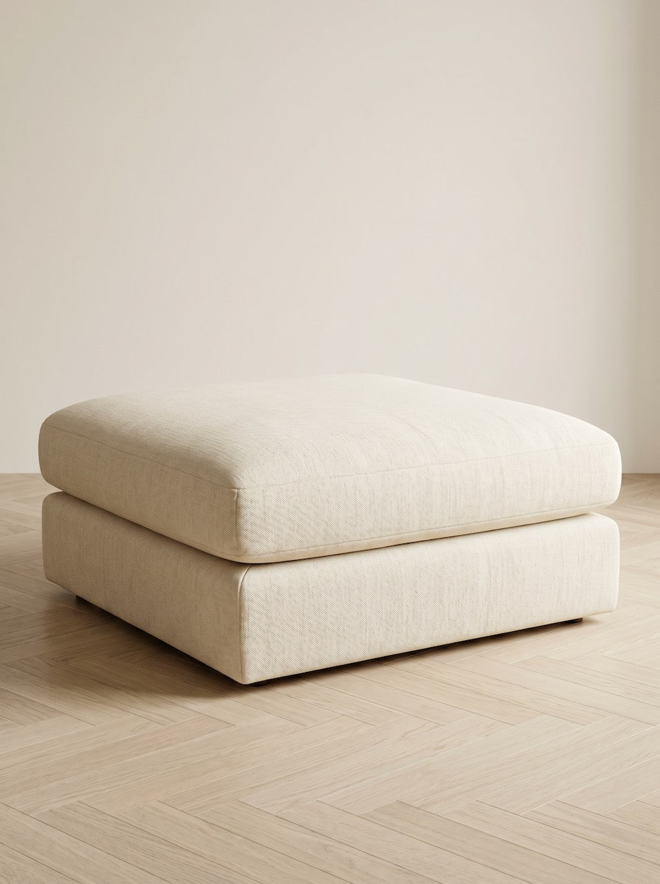 Soft cream upholstered foot stool
in a minimalist interior